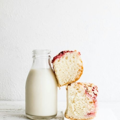 baked bread and black glass of milk