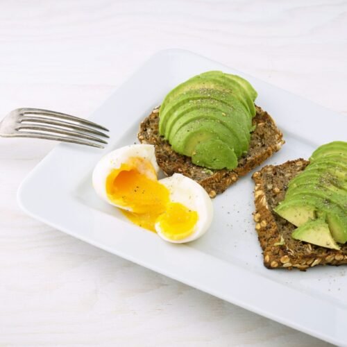 rectangular white platter of sliced food and eggs