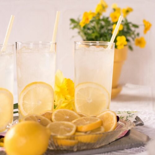 sliced lemon beside two clear drinking glasses